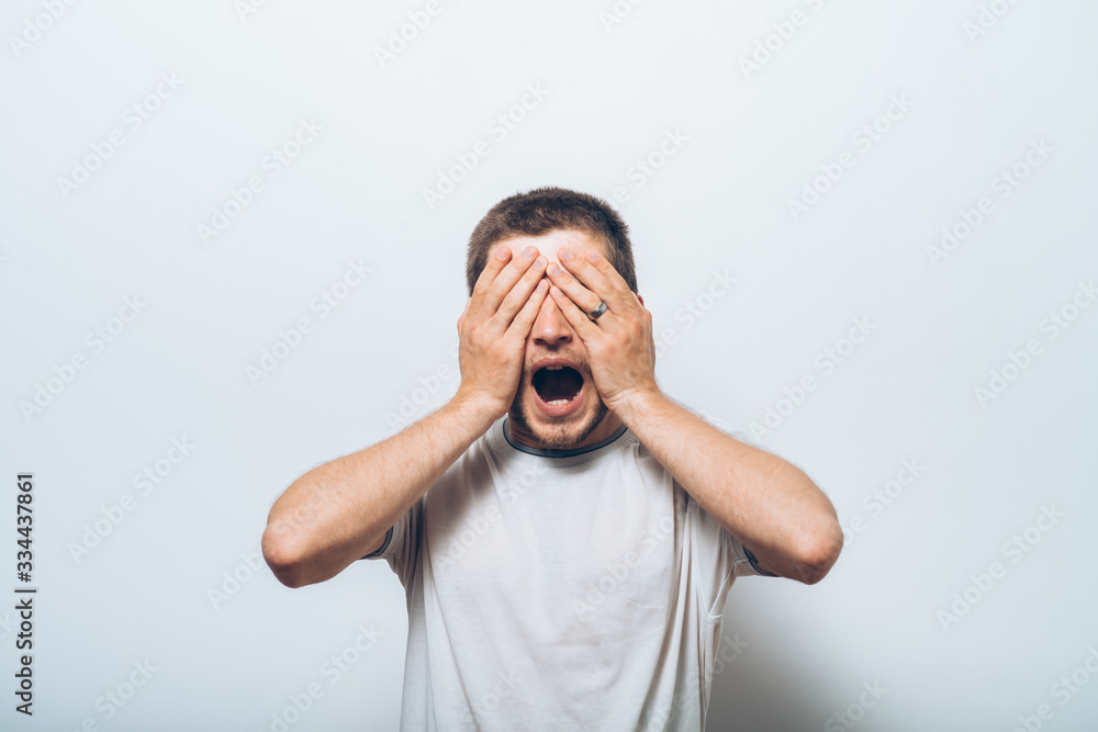 Man closes eyes with her hands Man closes eyes with her hands