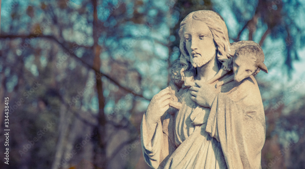 Ancient statue of Jesus Christ Good Shepherd with the lost sheep on his shoulders. Biblical tradition, religion, Christianity, God, faith concept