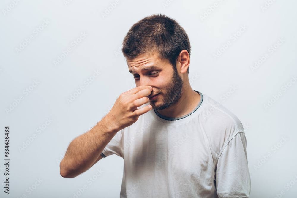 Fototapeta premium The stench. Closes the man's nose