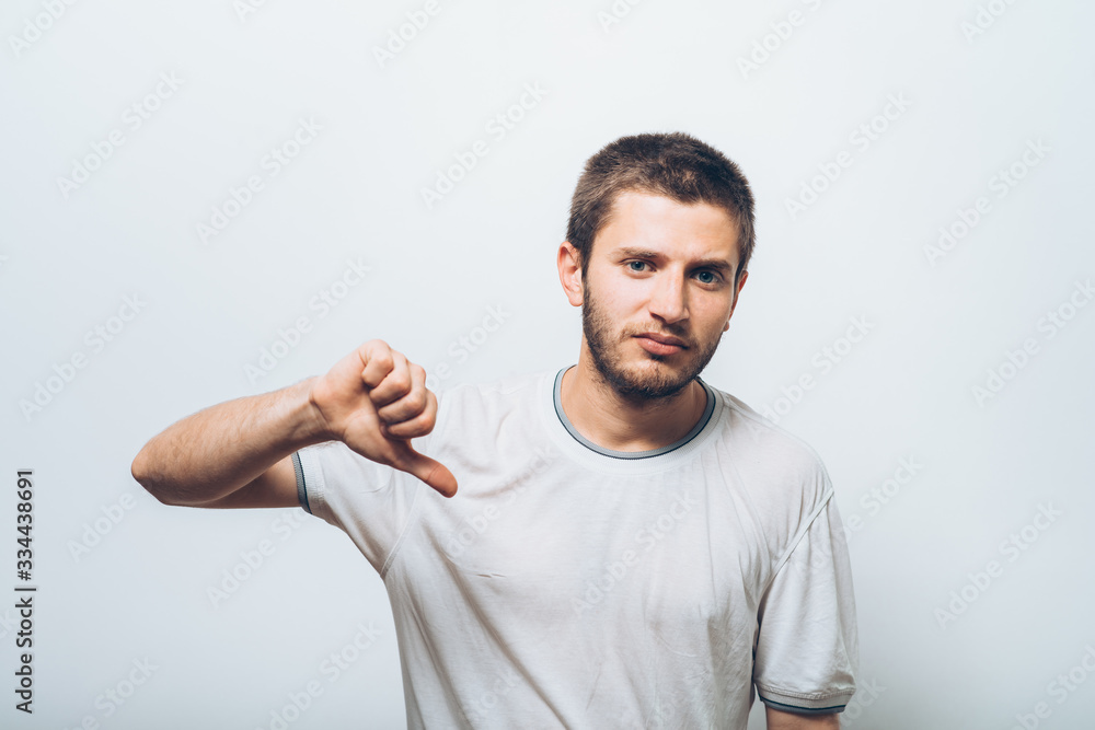 man showing a thumb down gesture man showing a thumb down gesture