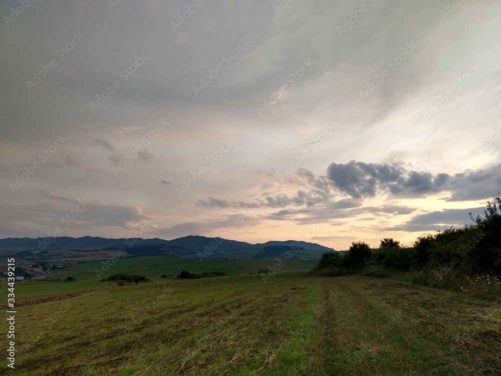 Fototapeta premium Sunrise or sunset over the hills and meadow. Slovakia