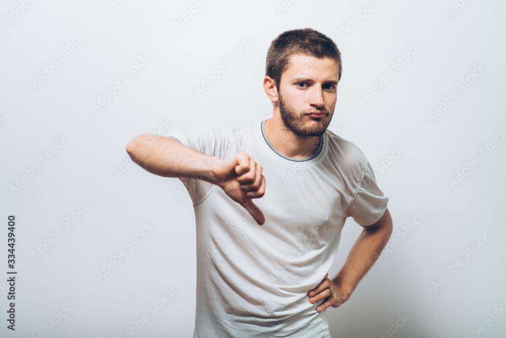 man showing a thumb down gesture man showing a thumb down gesture