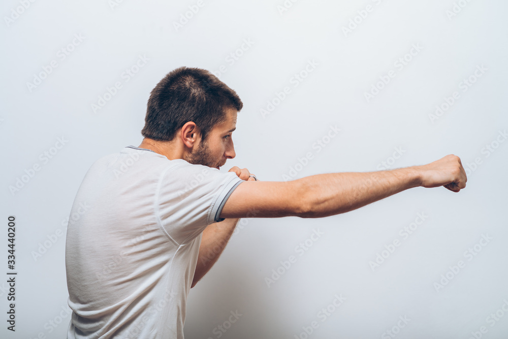 A man shows the first evil. Gray background A man shows the first evil. Gray background