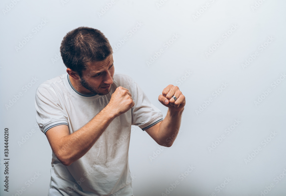A man shows the first evil. Gray background A man shows the first evil. Gray background