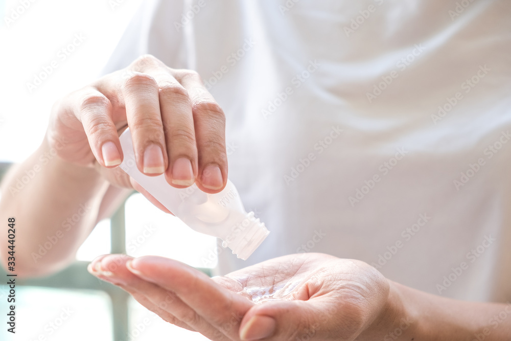 Asian women cleaning hand by alcohol gel to prevent spread of germs, bacteria and virus Asian women cleaning hand by alcohol gel to prevent spread of germs, bacteria and virus