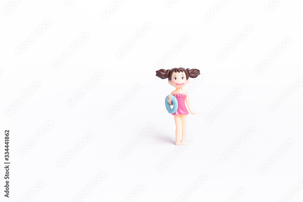 Cute little girl doll in pink swimsuite isolate on white background, summer fashion Cute little girl doll in pink swimsuite isolate on white background, summer fashion