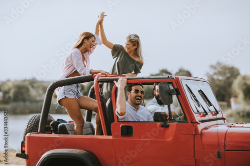Fotografia, Obraz Group of young people enjoying road trip