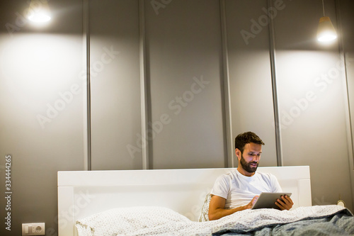 Young man reading book in t...