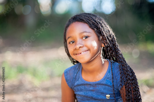 afro american girl smiling and looking at the camera with an peaceful expression