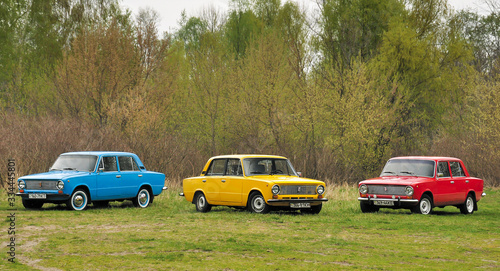 KIEV, UKRAINE-JULY 4, 2016: three retro cars VAZ-2101 "Zhiguli" parked on the green lawn of the forest at Old Car Fest show, JULY 4, 2016 in Kiev, Ukraine. Retro vehicles. Vintage classic cars.