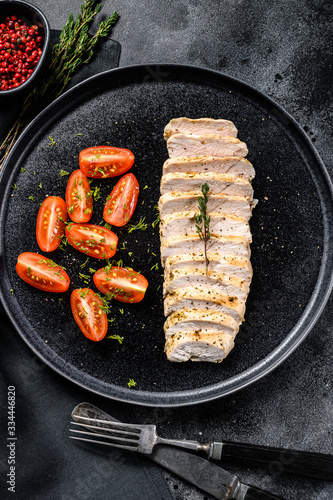 grilled chicken breast with fresh cherry tomatoes. Healthy diet food. black background. Top view