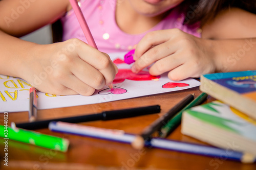 girl drawing slogan stay home, half body, in interior of latin homegirl drawing slogan stay home, half body, in interior of latin home photo