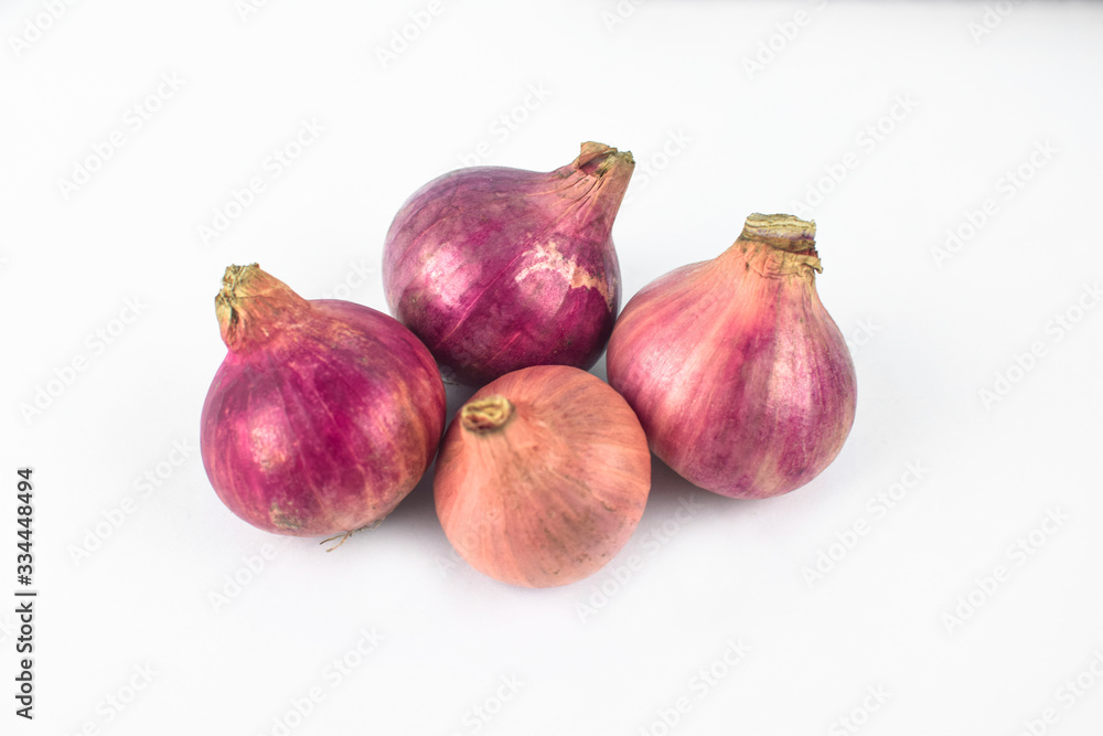 Four medium size fresh and ripe red onion isolated on a white background Four medium size fresh and ripe red onion isolated on a white background