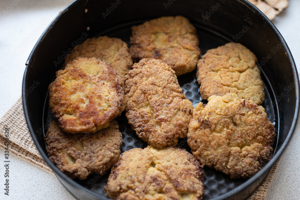 fried cutlet in a black pan, rustic food. close-up fried cutlet in a black pan, rustic food. close-up