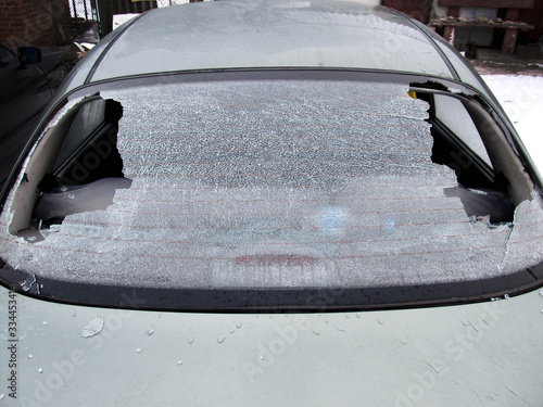 a crashed car heated rear window broken by an accidentally cast stone