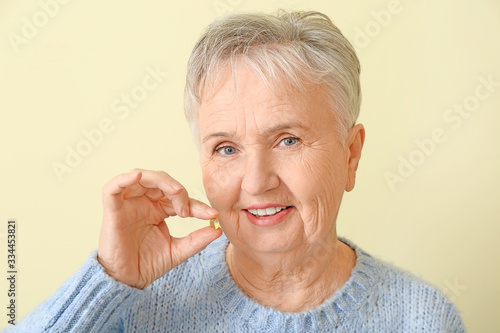 Senior woman with fish oil ...
