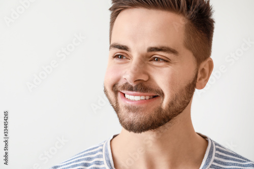 Handsome smiling young man on white background