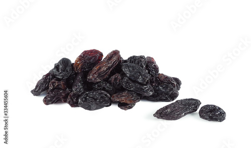 Obraz na plátně Heap of black seedless raisins (sultana) closeup isolated on white background