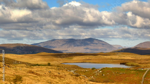 typical Irish landscape from Connemara, Galway Ireland with mountains, clouds and lakes