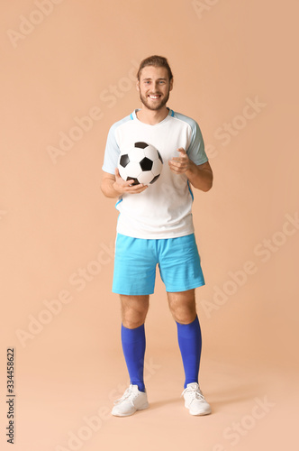 Fototapeta Naklejka Na Ścianę i Meble -  Male football player on color background