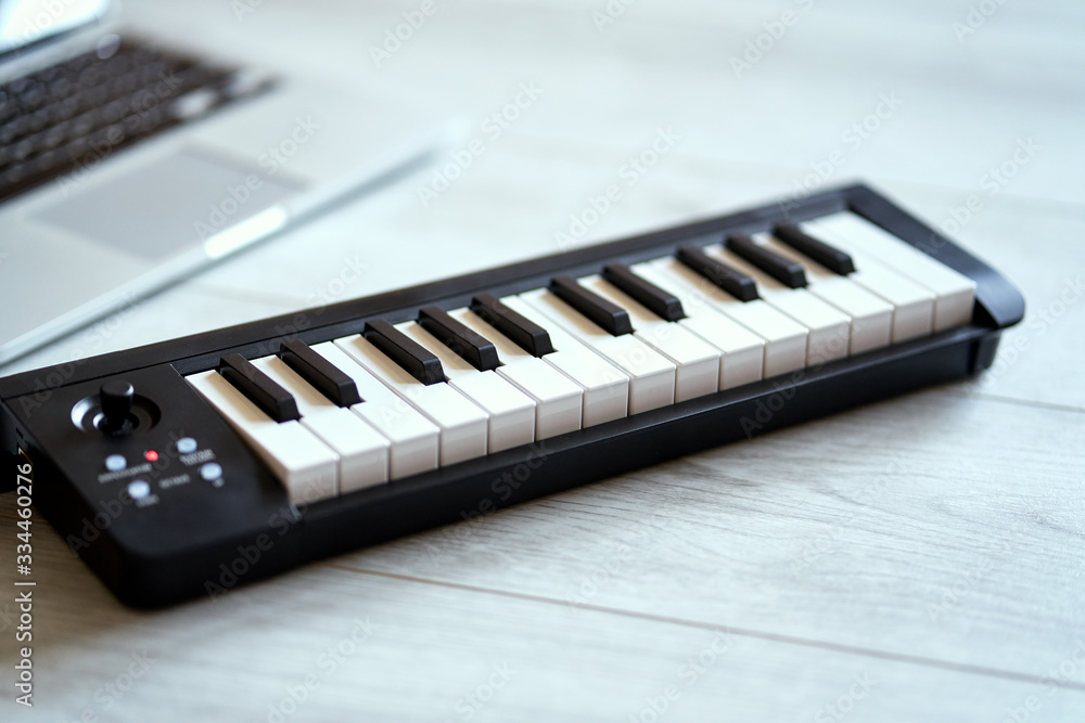 keyboard musical instrument on a white floor keyboard musical instrument on a white floor