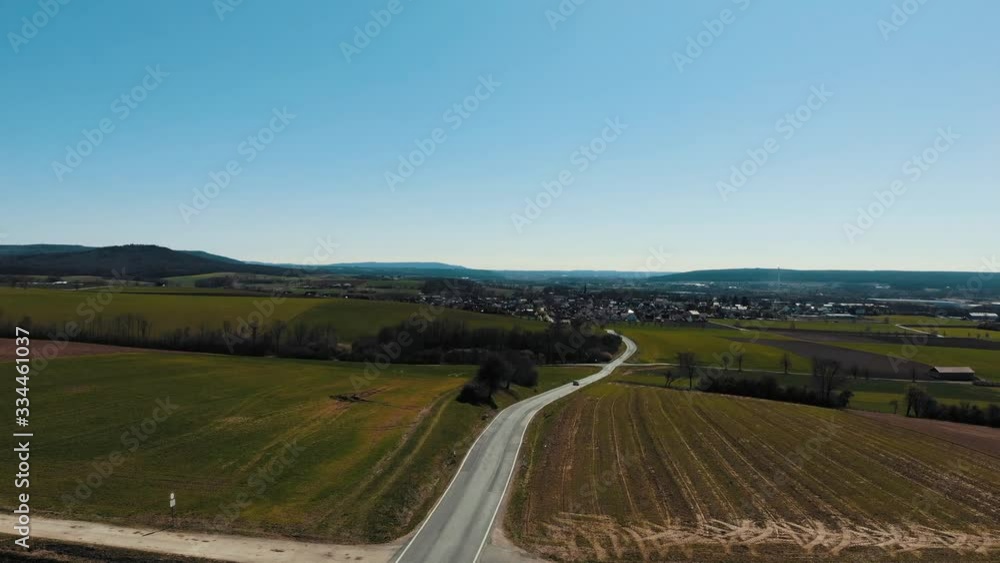 bamberg, germany drone shot of cars driving in rural area bamberg, germany drone shot of cars driving in rural area