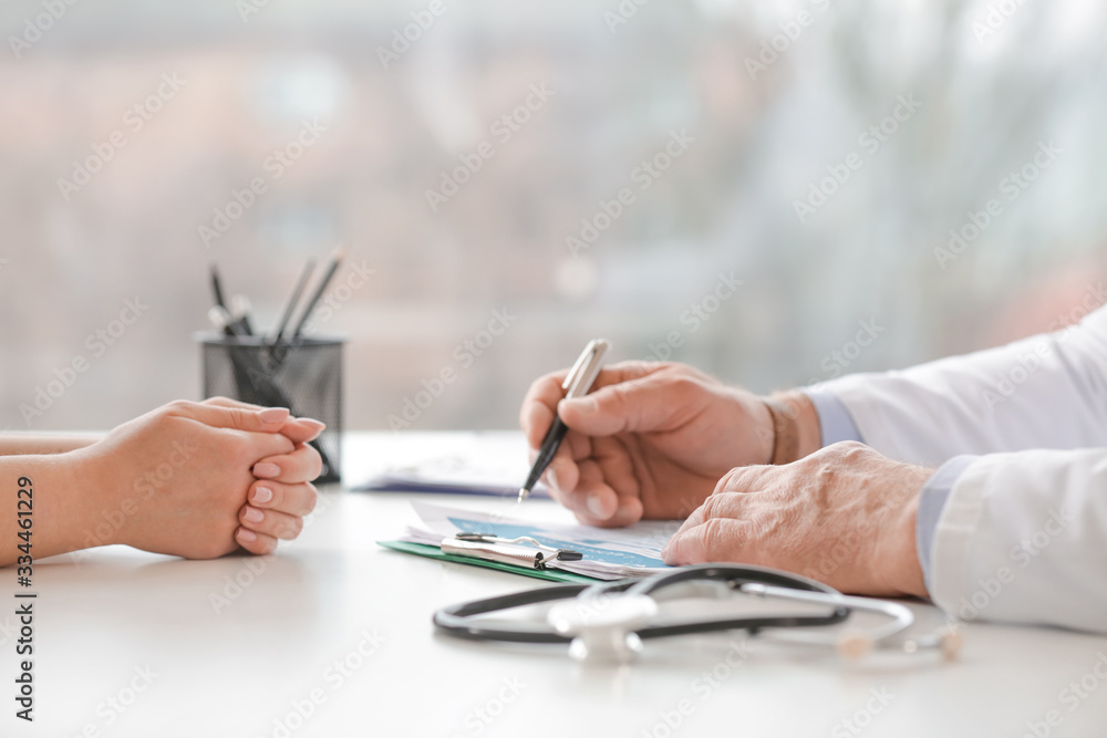 Male doctor working with patient in clinic Male doctor working with patient in clinic