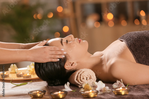 фотография Beautiful young woman receiving massage in spa salon