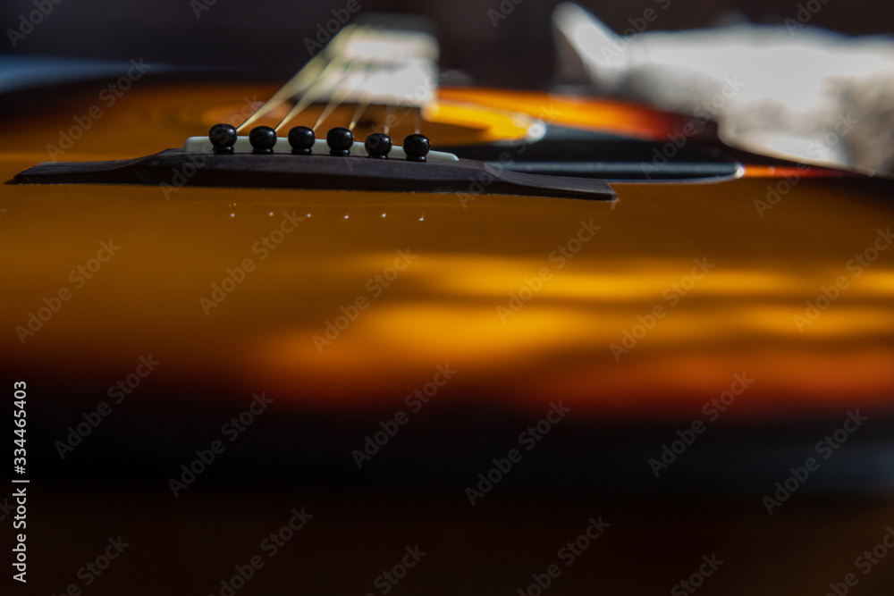Close up acoustic guitar bridge pin in the sun Close up acoustic guitar bridge pin in the sun