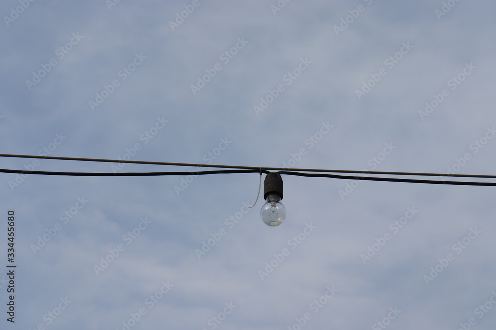 light bulb hanging on cable at street light bulb hanging on cable at street