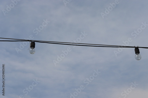 light bulb hanging on cable at street