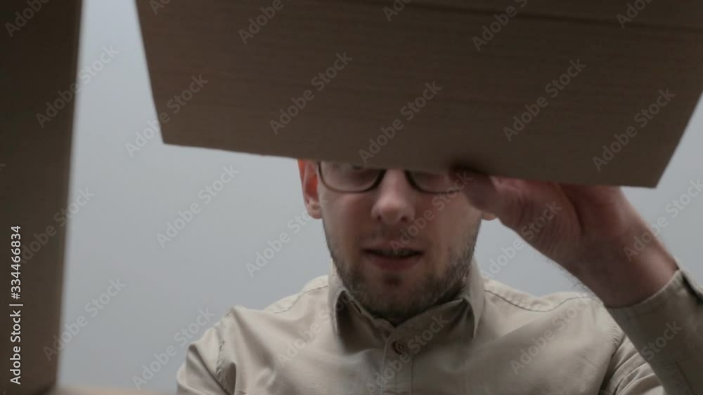Man opens the box, looks around and steals on the sly the contents of ...