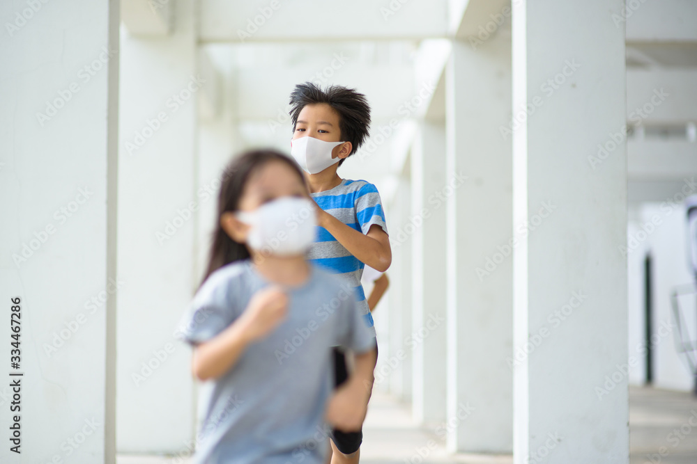 Young boy and girl wear mask and running.