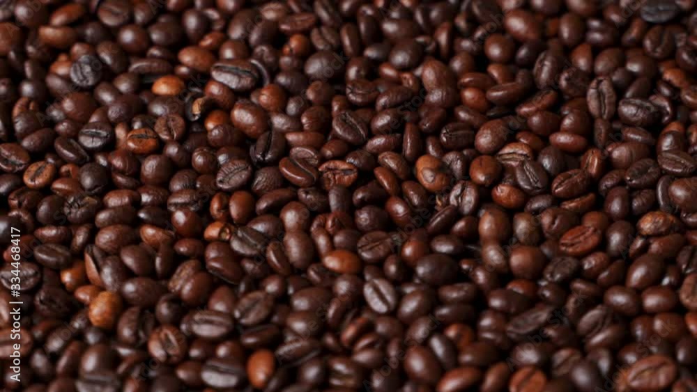 Close up of roasted brown coffee beans rotating Close up of roasted brown coffee beans rotating