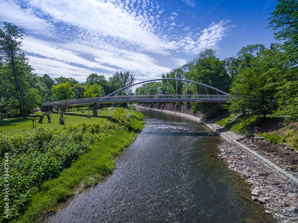 Fototapeta premium Aerial view of peasant bridge over river Olse between Cieszin and Czech Tesin. Border between Czech republic and Poland.