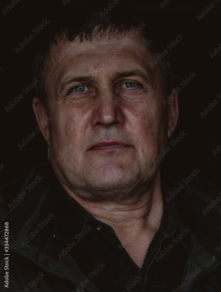 Obraz premium Portrait of mature handsome man with gray hair. Middle age brutal man on black background closeup photo