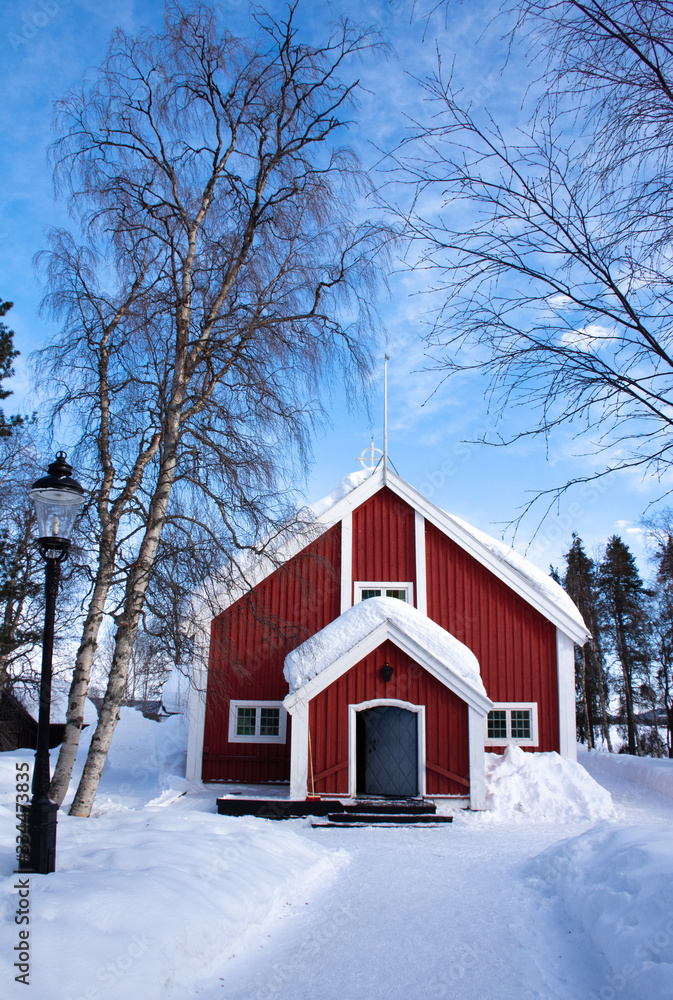  Beautiful winter weather at the colorful church of Jukkasjärvi, Jukkasjärvi kyrka,  in northern Sweden, Lapland.