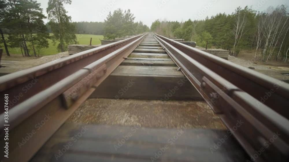 Abandoned narrow gauge railway on the bridge over raod, autumn day