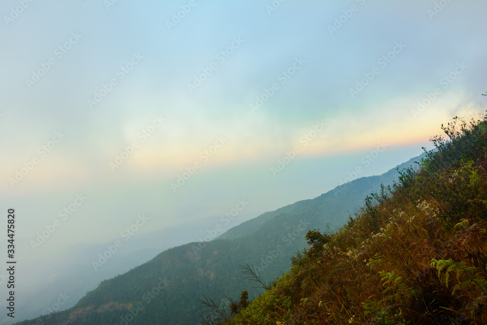 Nature landscape cloudy sky with mountain view and white fog in morning time at Thailand. Nature park and outdoor background