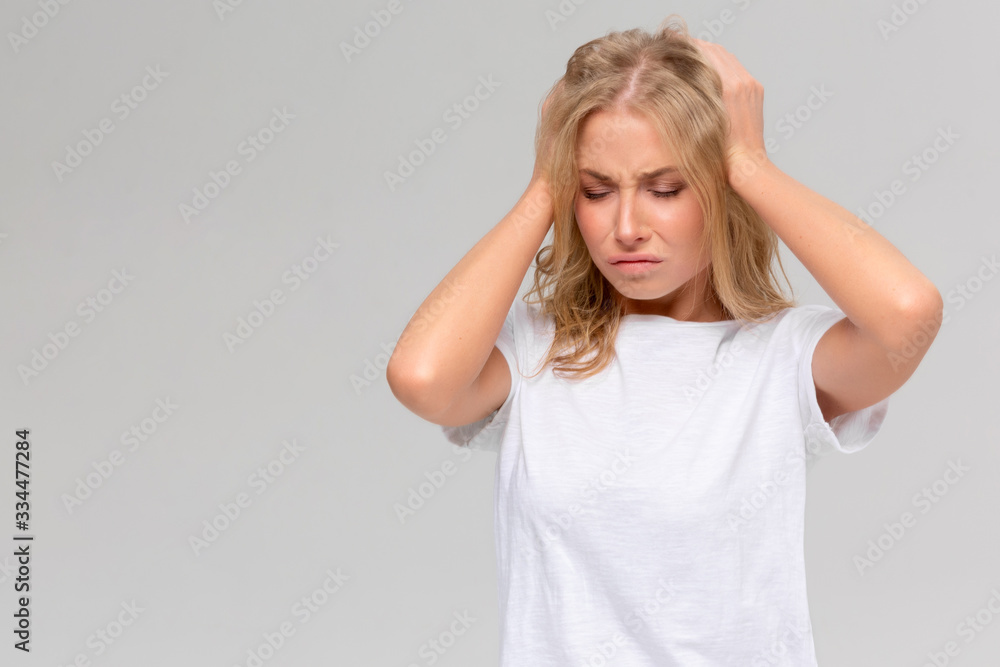 Isolated portrait of young woman with high temperature, headache. Covid-19 coronavirus symptoms Isolated portrait of young woman with high temperature, headache. Covid-19 coronavirus symptoms