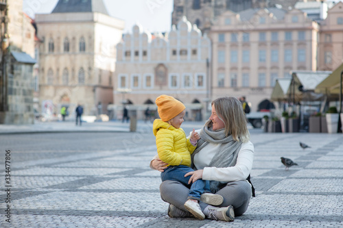 mother and daughter in empty old town square in Prague. Czech Republic