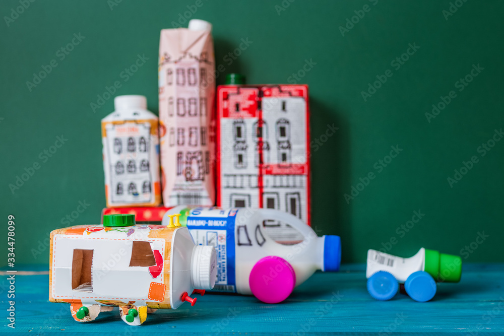 Houses and toy cars made from milk bags. DIY paper milk bag. Creative