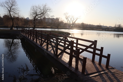 wooden lake pier in spring park © Mikalai Drazdou