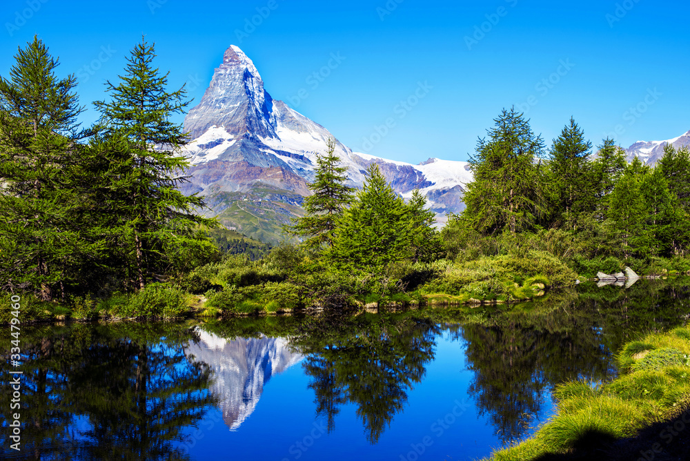 picturesque beautiful landscape with lake and fir trees on background Matterhorn in the Swiss Alps, near Zermatt, Switzerland. Amazing places. (Meditation, antistress - concept).