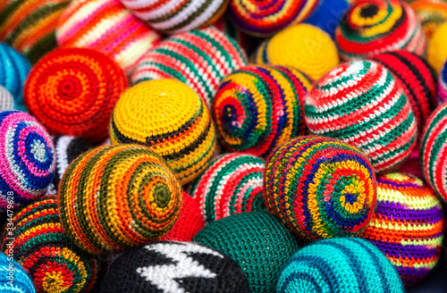 Side view of colorful fabric balls of wool on the Andean craft market of Otavalo, north of Quito, Ecuador.