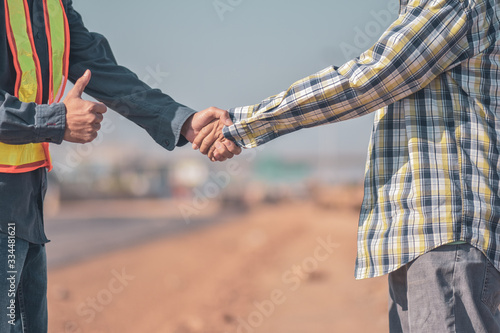 Engineer Foreman Two people are shake hands to congratulation success agreement concept,two people are partner in occupation © Suriyo
