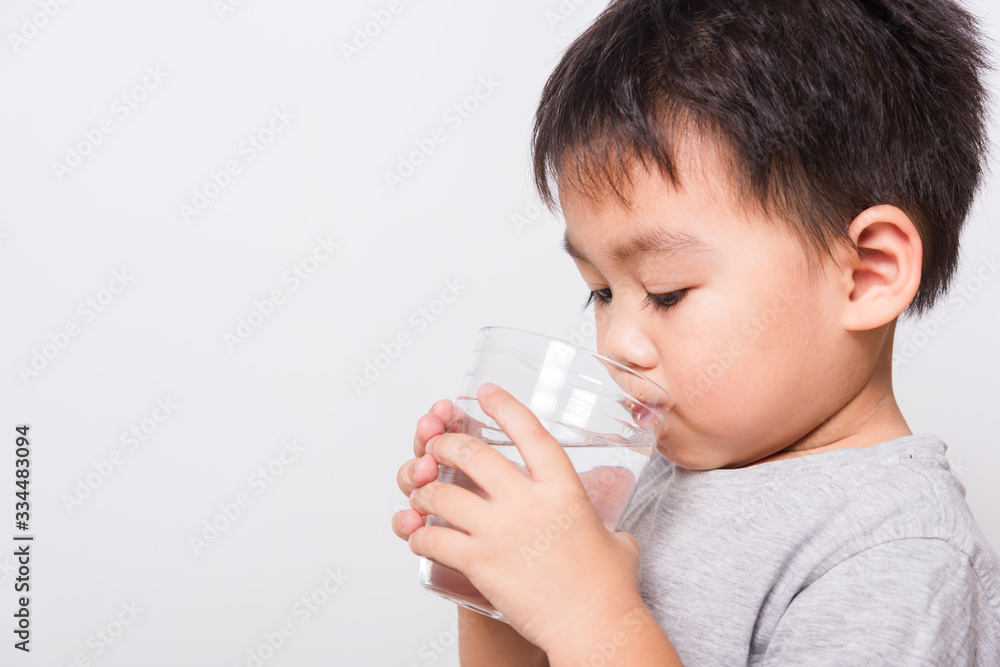 Closeup Asian face, Little children boy drinking water from glass Closeup Asian face, Little children boy drinking water from glass
