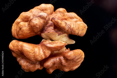 Obraz na płótnie walnut lies on a black surface. closeup. peeled nut