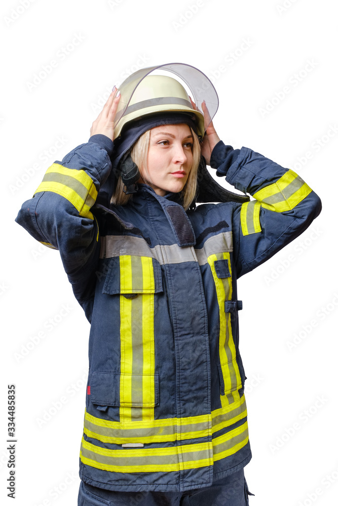 young serious women firefighter puts a helmet on his head. young serious women firefighter puts a helmet on his head.
