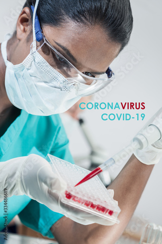 Asian Female Scientist With Blood Sample In Coronavirus COVID-19 Laboratory